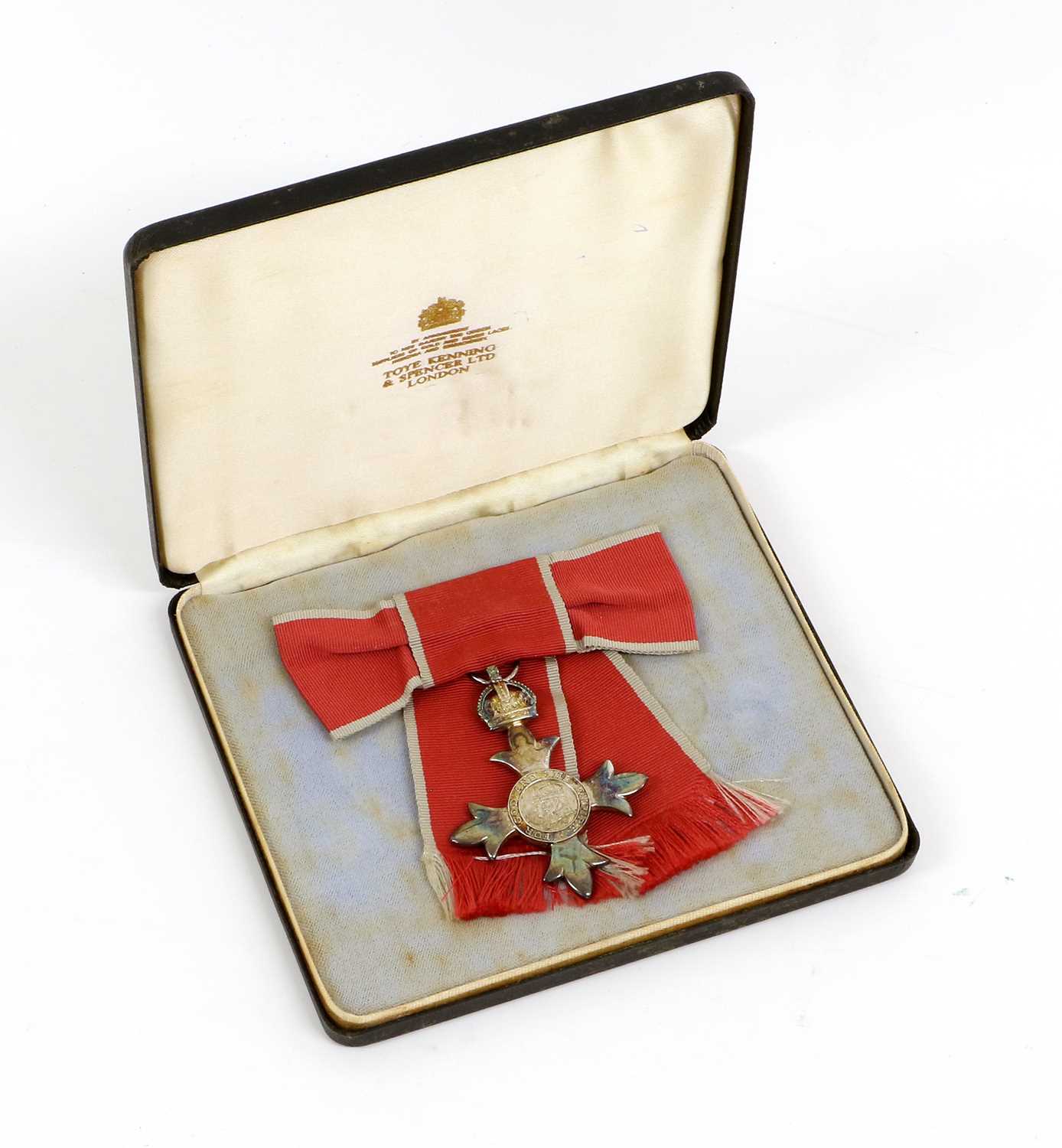 Lot 25 - An MBE Breast Badge, in case of issue, awarded...