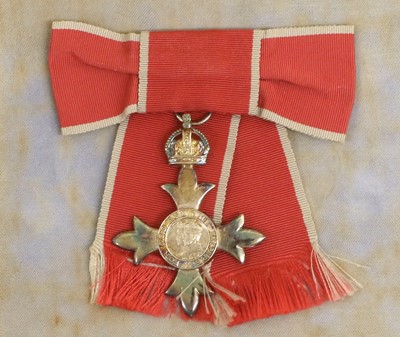 Lot 25 - An MBE Breast Badge, in case of issue, awarded...