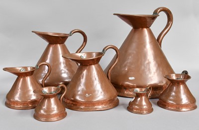 Lot 284 - A Set of Seven Copper Graduated Harvest Jugs,...