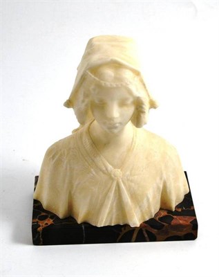 Lot 104 - Carved alabaster bust of a maiden on a veined black marble base