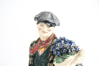 Lot 223 - A Chelsea Pottery Group "The Cineraria Boy",...