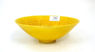 Lot 162 - A Chinese Yellow Ground Conical Bowl, in Ming style, moulded with calligraphy in panels on a ground