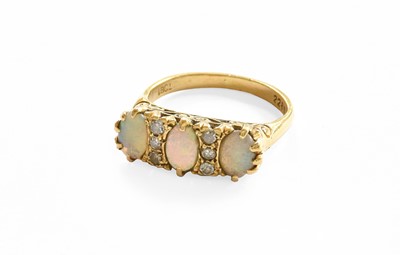 Lot 52 - An Opal and Diamond Ring, three oval opals...