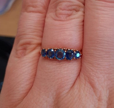 Lot 2136 - A Sapphire Five Stone Ring the graduated oval...