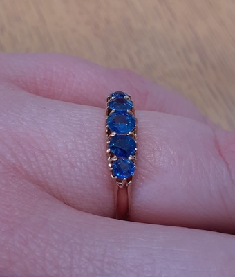 Lot 2136 - A Sapphire Five Stone Ring the graduated oval...