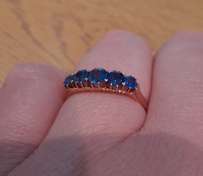 Lot 2136 - A Sapphire Five Stone Ring the graduated oval...