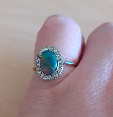 Lot 2042 - An Opal and Diamond Cluster Ring the oval...