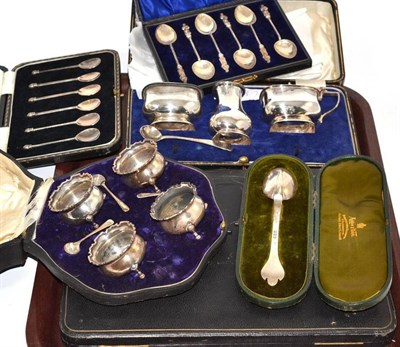 Lot 189 - A collection of cased silver including a four piece salt set, a three piece cruet set, two sets...