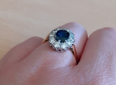 Lot 2074 - A Sapphire and Diamond Cluster Ring the oval...