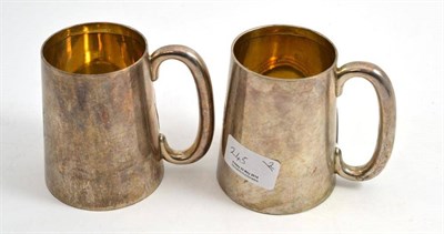Lot 245 - A pair of silver mugs, Birmingham 1928, one with a glass bottom