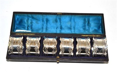 Lot 246 - A set of six Victorian silver napkin rings, Sheffield 1887, in original fitted leather case