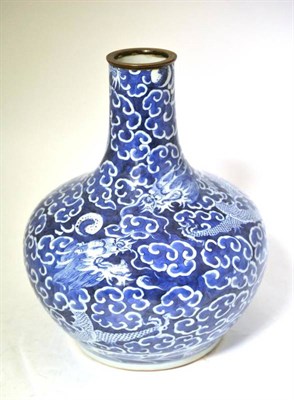 Lot 177 - A Chinese Porcelain Bottle Vase, 18th century, painted in underglaze blue with dragons chasing...