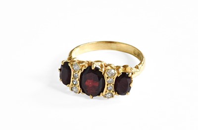 Lot 392 - An 18 Carat Gold Garnet and Diamond Ring,...