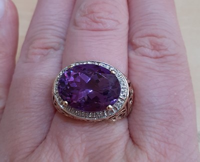 Lot 2180 - An Amethyst and Diamond Cluster Ring the oval...