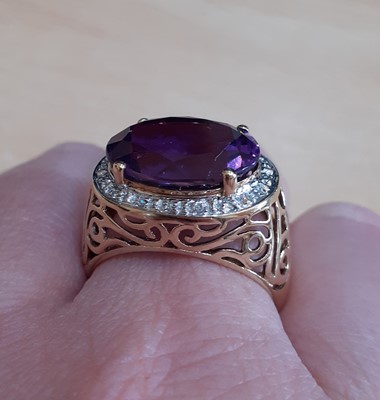 Lot 2180 - An Amethyst and Diamond Cluster Ring the oval...