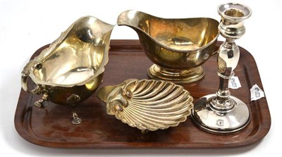 Lot 280 - A Victorian silver shell shaped butter dish, London 1892, also a silver sauce boat on hoof...