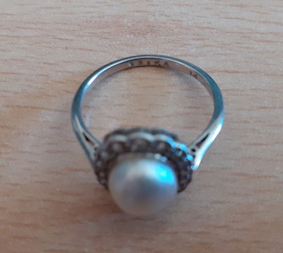Lot 2041 - A Pearl and Diamond Cluster Ring the button...