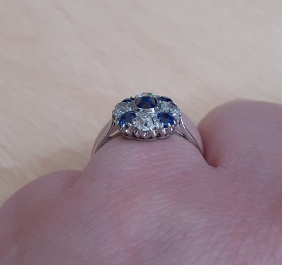 Lot 2058 - A Sapphire and Diamond Cluster Ring the oval...