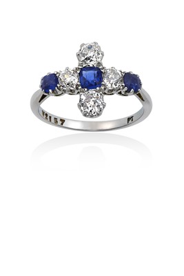 Lot 2156 - A Sapphire and Diamond Ring the cross motif...