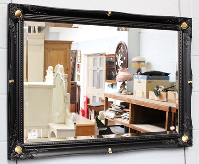 Lot 1386 - A Ebonised and Parcel Gilt Wall Mirror