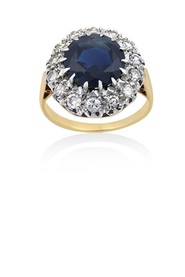 Lot 2155 - A Sapphire and Diamond Cluster Ring the round...