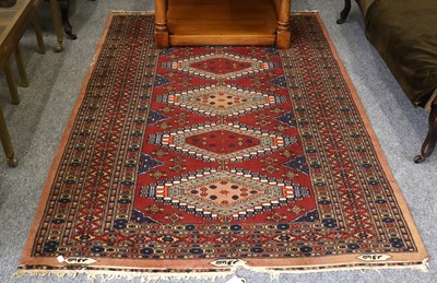 Lot 1205 - A Kashmir Bukhara Rug, the deep brick red...