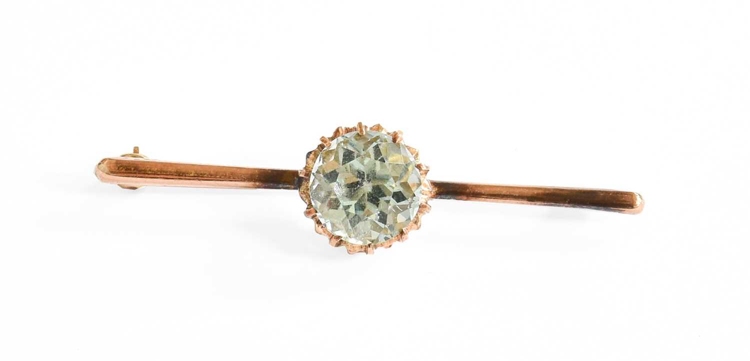 Lot 34 - An Aquamarine Brooch, the round cut aquamarine...