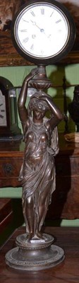 Lot 329 - Spelter model of a lady holding an eight-day clock