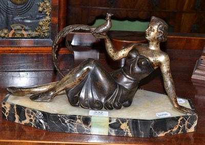 Lot 332 - Art Deco spelter figure of a reclining lady holding an exotic bird