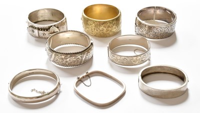 Lot 420 - Eight Silver and White Metal Bangles, of...