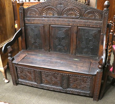 Lot 1311 - A Carved Oak Box Settle, 18th century elements,...