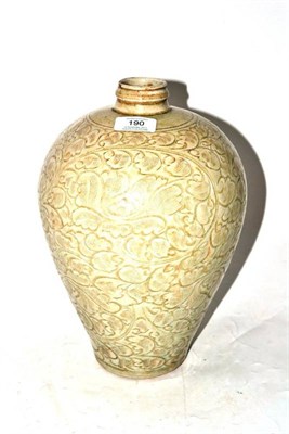 Lot 190 - A Chinese Celadon Glazed Ovoid Jar, in Song style, carved with stylised flowers and leafy branches