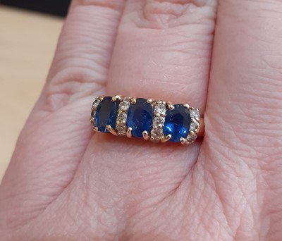 Lot 2149 - A Sapphire and Diamond Ring the three oval cut...