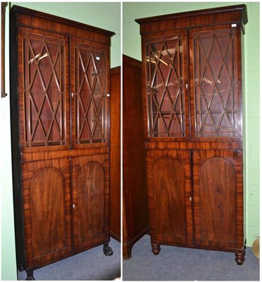 Lot 470 - A near pair of Regency mahogany bookcases with boxwood strung astragal glazed doors over two...