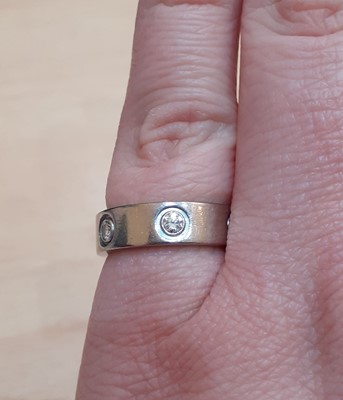 Lot 2299 - A Diamond Set 'Love' Ring, by Cartier the...
