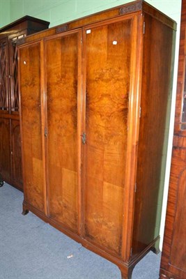 Lot 471 - A walnut triple wardrobe