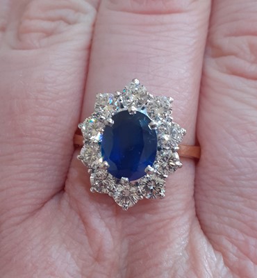 Lot 2319 - An 18 Carat Gold Sapphire and Diamond Cluster...