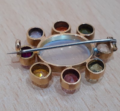 Lot 2113 - A Multi Gem-Set Brooch the oval cabochon...