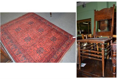 Lot 480 - Red rug and leather seated chair