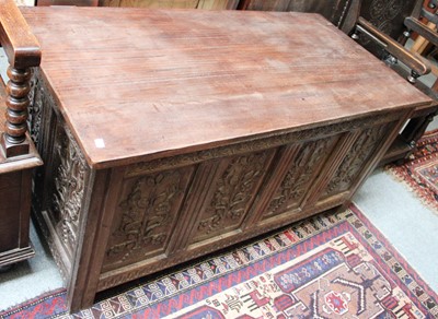 Lot 1156 - A Carved Oak Four Panel Blanket Chest, with...