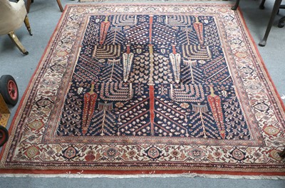 Lot 1080 - An Indian Carpet, the deep indigo field with a...