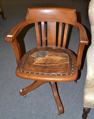 Lot 514 - An oak swivel office chair