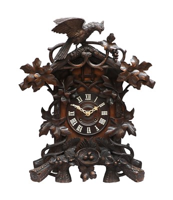 Lot 689 - A Black Forest Striking Cuckoo Table Clock,...