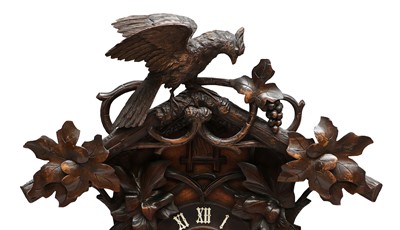 Lot 689 - A Black Forest Striking Cuckoo Table Clock,...