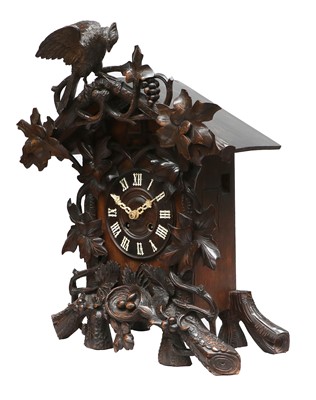 Lot 689 - A Black Forest Striking Cuckoo Table Clock,...