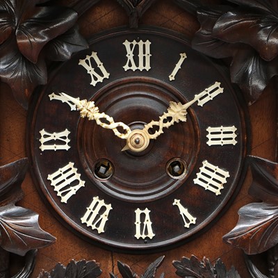 Lot 689 - A Black Forest Striking Cuckoo Table Clock,...