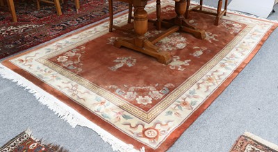 Lot 1093 - A Chinese Carpet, the terracotta field...