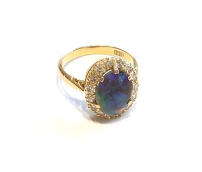 Lot 358 - A Black Opal and Diamond Cluster Ring, the...