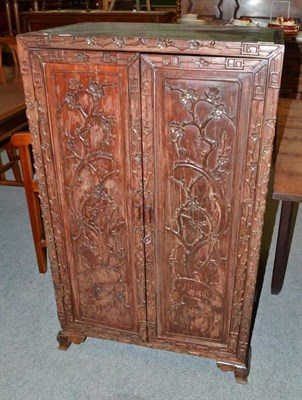 Lot 536 - A Chinese carved hardwood cabinet