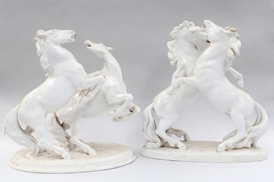 Lot 105 - A Pair of White Porcelain Fighting Stallions,...